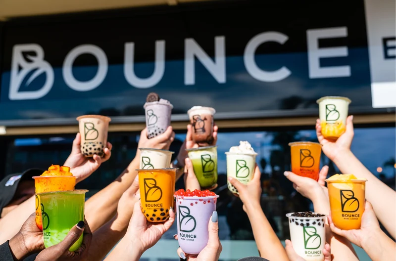 Customers holding colorful Bounce Boba Lounge drinks outside the Northridge shop